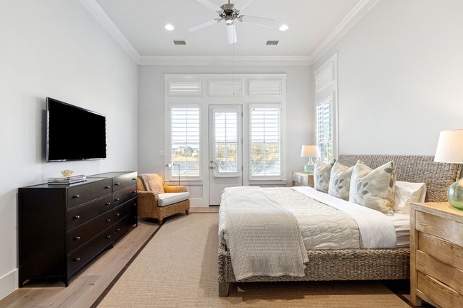 Bedroom featuring ornamental molding, visible vents, and multiple windows | Image 16