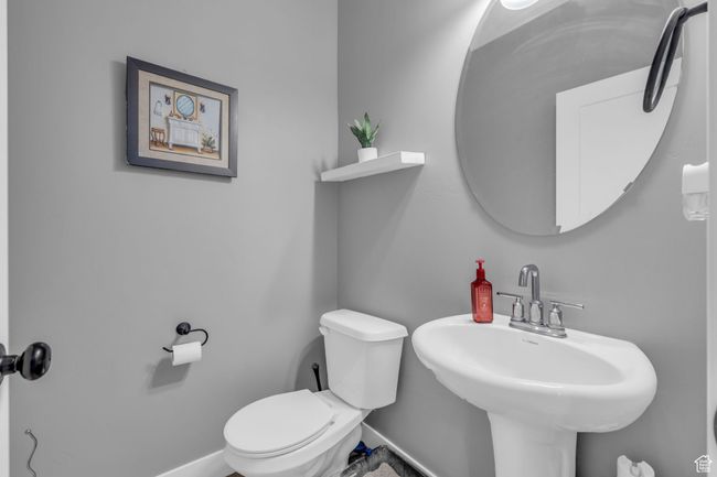 Bathroom with baseboards, a sink, and toilet | Image 10