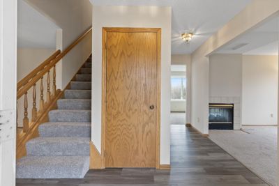 Foyer with a coat closet and the living room to the right and the dining room to the left. | Image 3