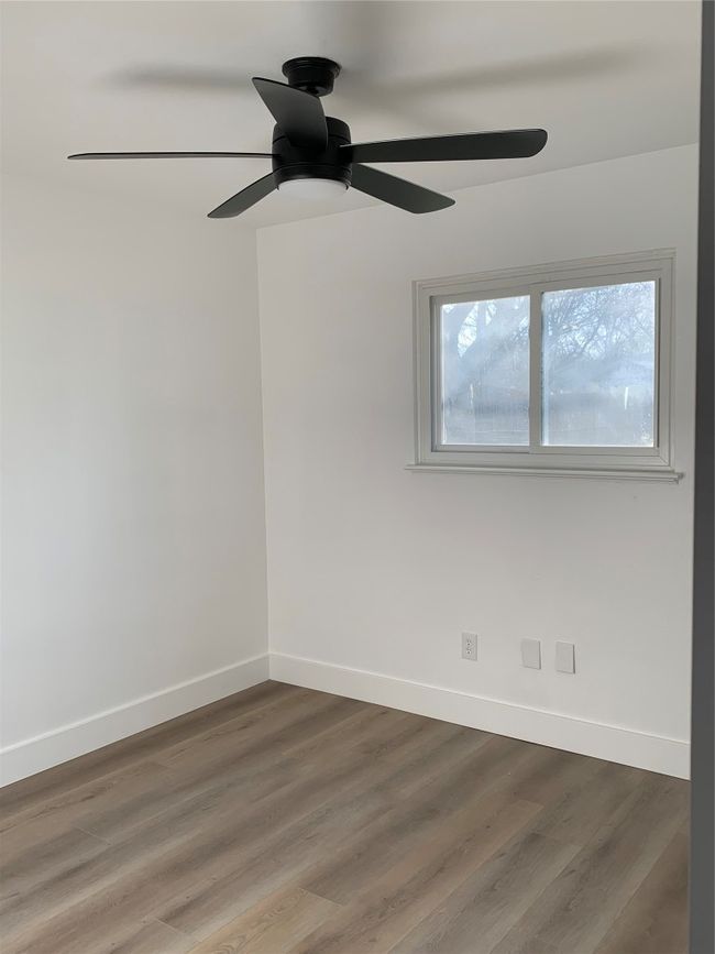 Spare room featuring ceiling fan and wood finished floors | Image 23