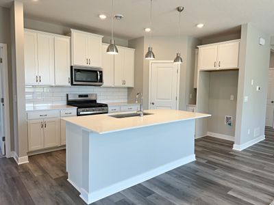 Open kitchen with excellent lighting and quality finishes. Photo of similar Home. Options and colors may vary. Ask Sales Agent for details. | Image 3