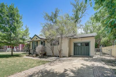 View of front of home featuring a garage and a front lawn | Image 1