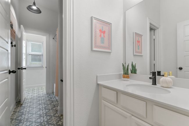 Full bath with vanity, tile patterned floors, curtained shower, and baseboards | Image 35