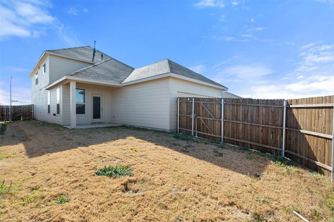 Back of property featuring a fenced backyard, roof with shingles, and a patio area | Image 18