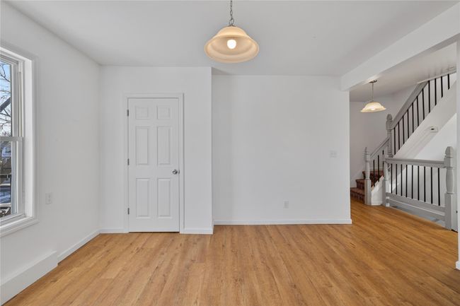 Unfurnished room with a healthy amount of sunlight and light wood-type flooring | Image 15