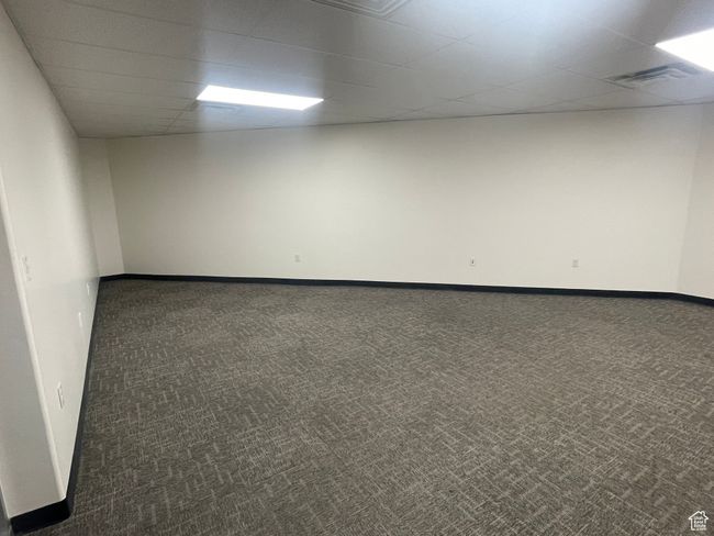 Spare room featuring baseboards, visible vents, a paneled ceiling, and carpet | Image 4