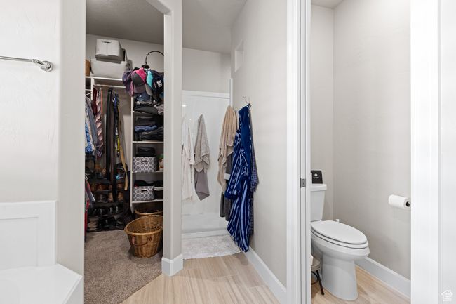 Full bath featuring a walk in closet and wood finished floors | Image 29