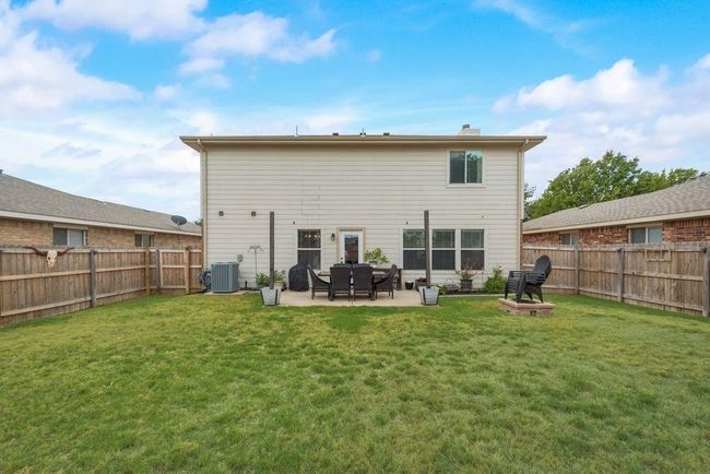 Rear view of property featuring a fenced backyard and a patio | Image 25