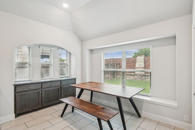 Arched butler pantry with extra cabinets and counters for entertaining. Breakfast area is big enough to seat 8-12. | Image 17