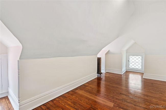 Bedroom with wood finished floors, lofted ceiling, and baseboards | Image 47