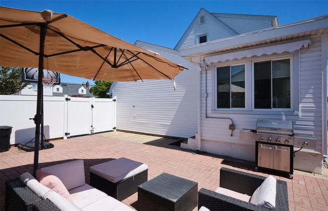 View of patio / terrace with a gate, an outdoor hangout area, area for grilling, and fence | Image 24