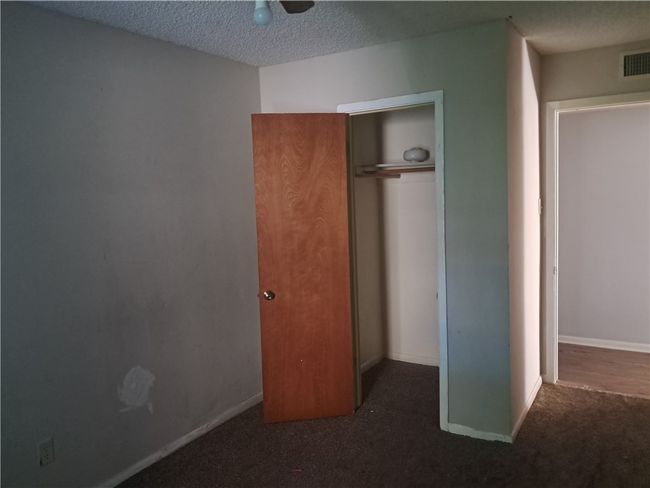Unfurnished bedroom with carpet floors, a closet, and a textured ceiling | Image 9