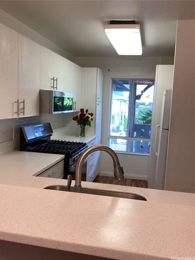 Kitchen with stack washer/dryer | Image 13