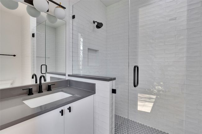 Bathroom featuring a stall shower, vanity, and toilet | Image 13