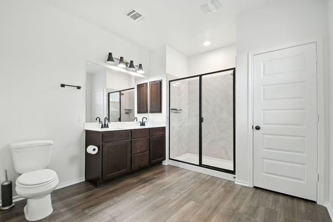 Bathroom with a shower stall and dark wood-type flooring | Image 20