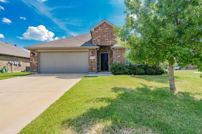 View of front of home with a garage and a front lawn | Image 2