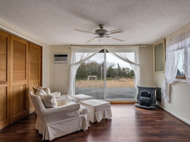 Sitting area with large sliders and rooftop deck to enjoy the views. | Image 16