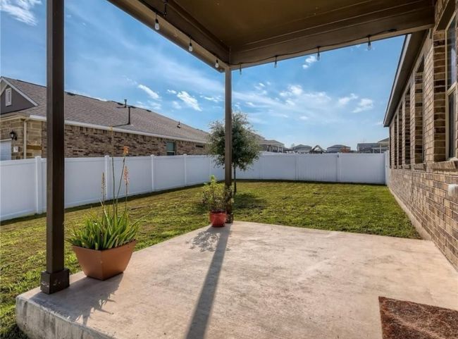 Fenced backyard with a patio area | Image 4