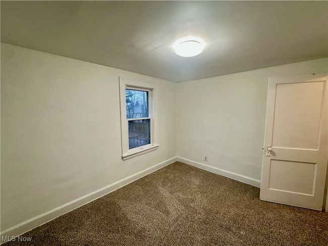 Unfurnished room with dark carpet and baseboards | Image 19