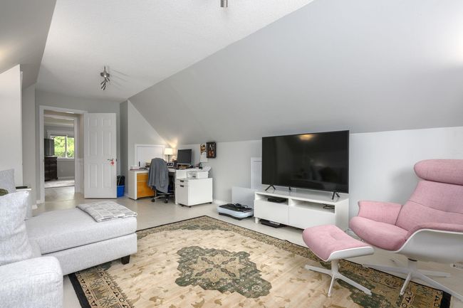 Living area with lofted ceiling and an office area | Image 20