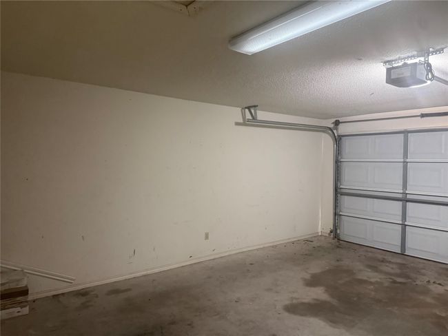 Garage featuring a garage door opener and baseboards | Image 22