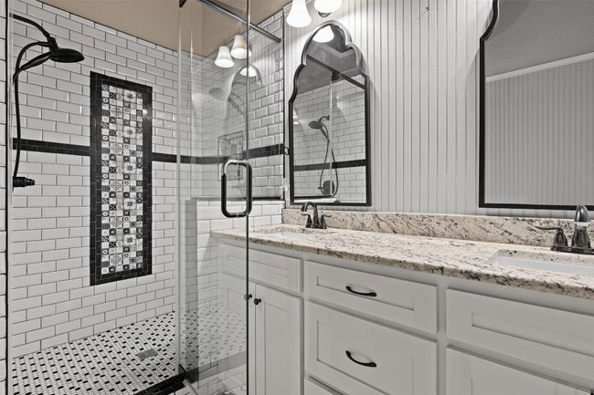 Full bath with a sink, double vanity, and a stall shower | Image 22