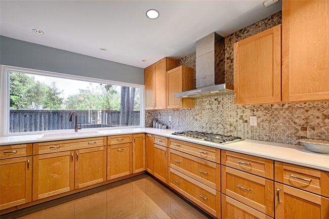 Chef's kitchen with lots of counter space and cabinetry. Gas range. | Image 24