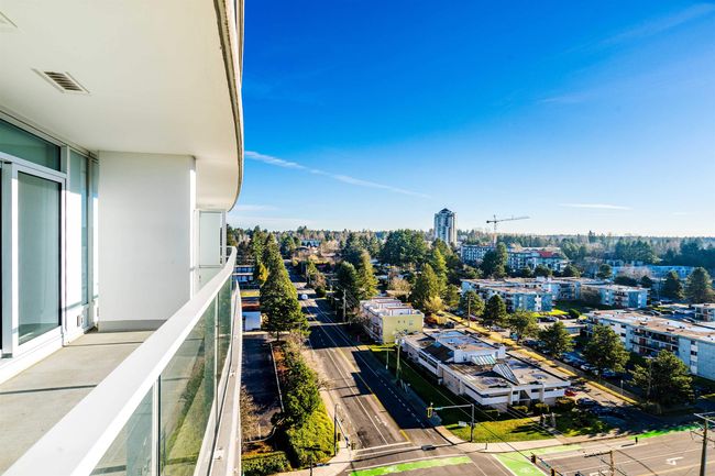 Balcony featuring a city view and visible vents | Image 12