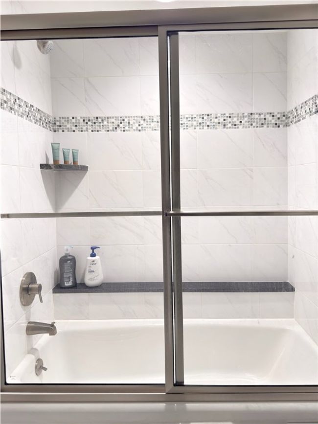 Detailed tiled shower w galss doors | Image 18