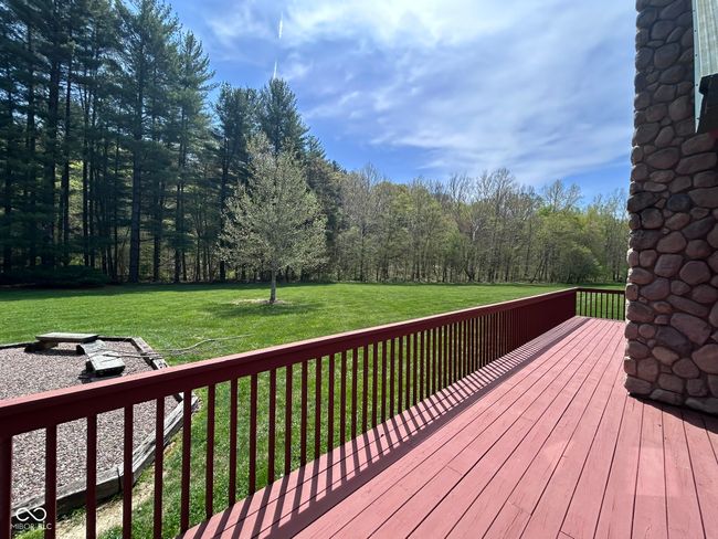 wooden terrace featuring a yard and a view of trees | Image 14