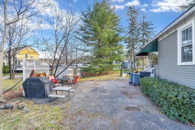 View of yard with an outdoor structure, a storage shed, and a patio area | Image 45