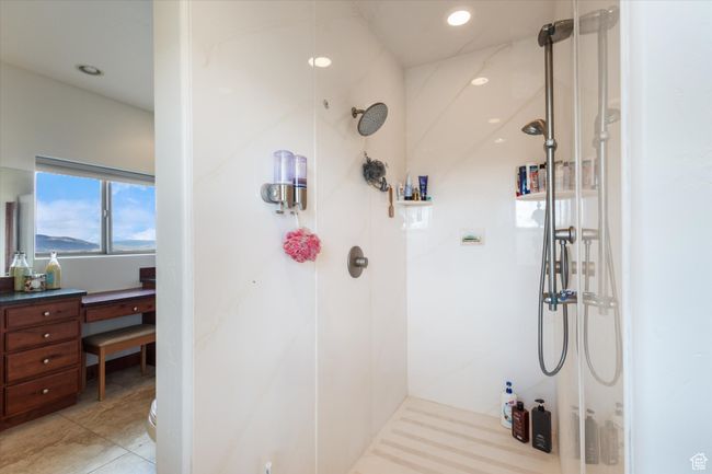 Bathroom with tile patterned flooring, a marble finish shower, and recessed lighting | Image 13