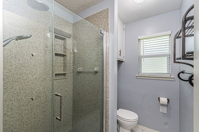 Full bathroom with baseboards, a shower stall, and toilet | Image 18
