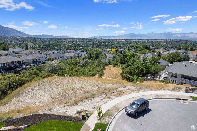 Aerial view of residential area featuring a mountainous background | Image 30