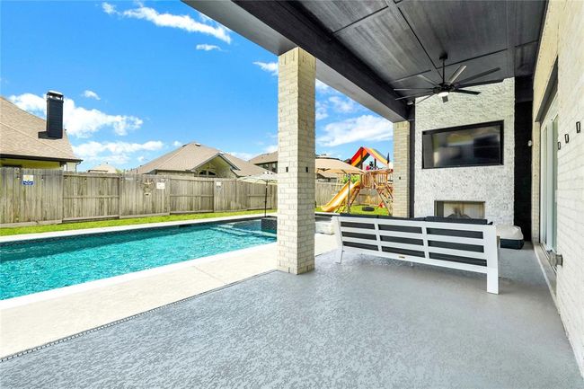 Custom built electric fireplace with TV and patio ceiling fans. Outlets in patio ceilling. | Image 6