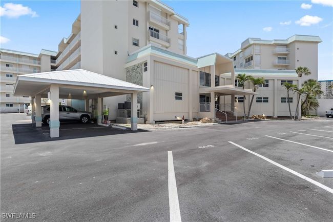 The building’s front offers a clean, welcoming façade framed by tropical landscaping, perfectly capturing its beachfront charm. | Image 25