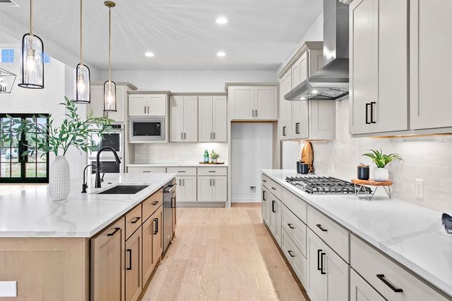 Kitchen with wall chimney exhaust hood, appliances with stainless steel finishes, recessed lighting, light wood-style flooring, and backsplash | Image 8