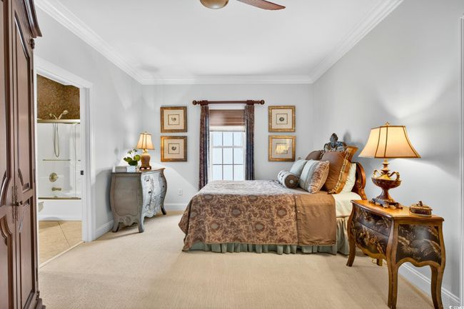 Carpeted bedroom featuring ornamental molding and connected bathroom | Image 29