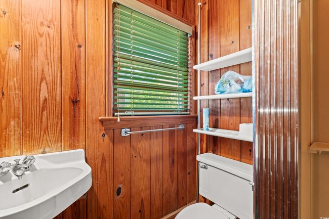 Half bathroom featuring wood walls | Image 19