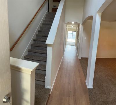 Stairway featuring a high ceiling and hardwood / wood-style flooring | Image 3