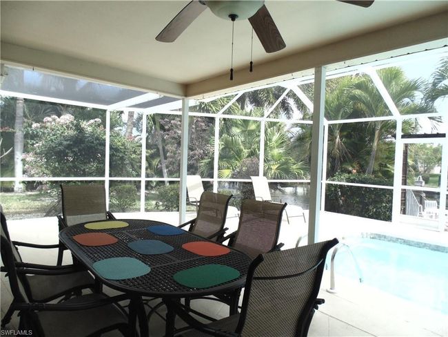 Sunroom with ceiling fan, a healthy amount of sunlight, and outdoor dining space | Image 29