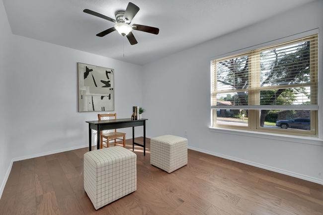 Home office with wood finished floors and ceiling fan | Image 12