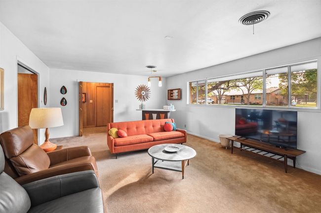 Carpeted living room with baseboards | Image 12