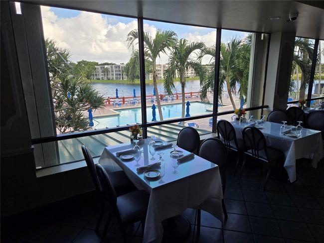 Upstairs Lake room Dining Room Overlooking Pool Area And Lake And Water Fountain | Image 8