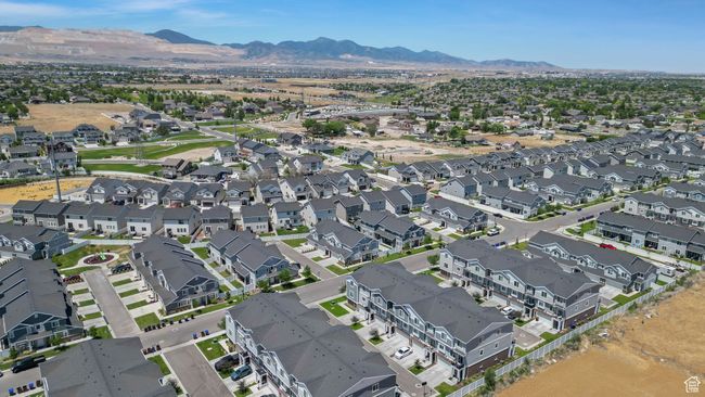 Aerial overview of property's location featuring a mountain backdrop and nearby suburban area | Image 5