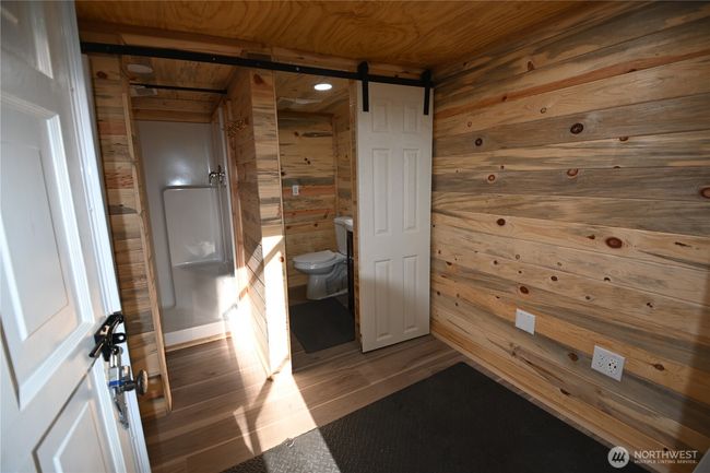 The washhouse a separate building featuring shower w/infrared heater, on-demand hot water, full laundry setup and space to add a sauna. | Image 29