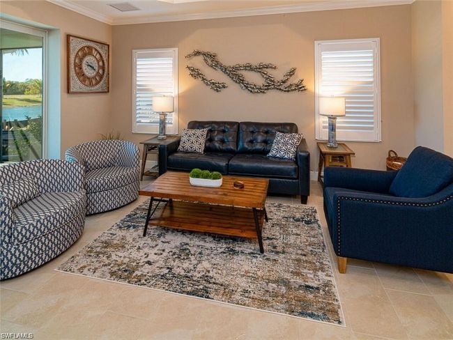 Living room with ornamental molding and light tile patterned floors | Image 6