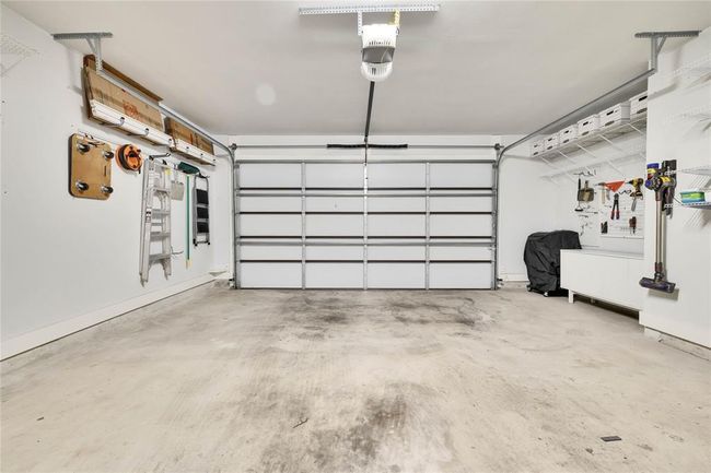 Garage with a garage door opener | Image 11