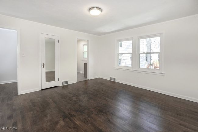 Unfurnished bedroom with dark hardwood / wood-style floors and crown molding | Image 23