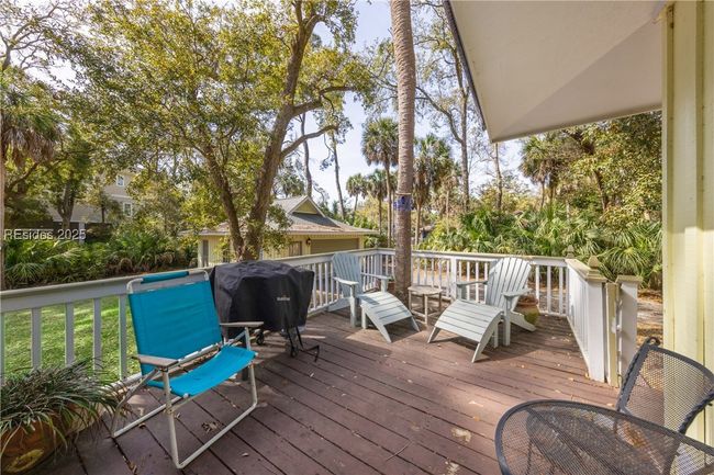 Screened in covered lanai is a wonderful spot for morning coffee or relaxing afternoon cocktails, while an adjacent seperate porch serves as a bbq space. | Image 56